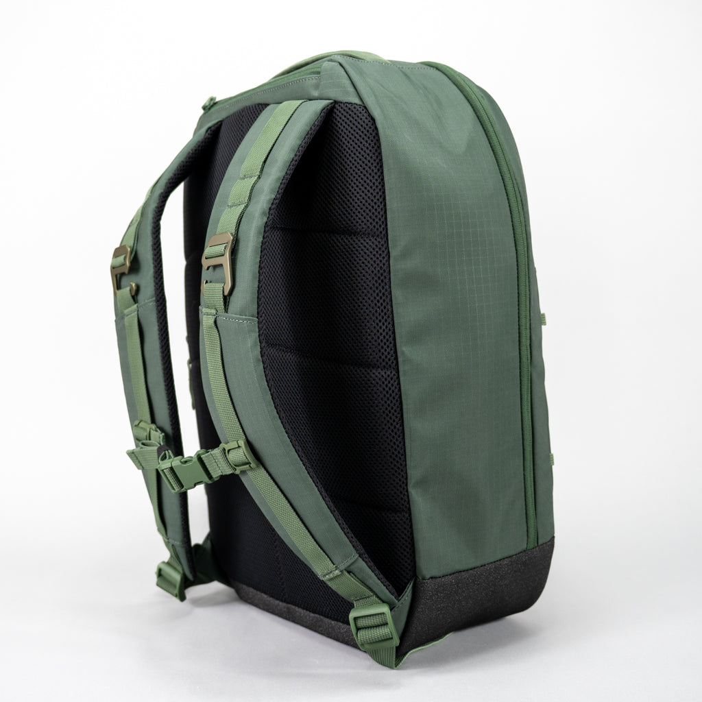 Rear view of the green FORWRD Court Ranger pickleball backpack featuring a ventilated mesh back panel, padded adjustable shoulder straps with sternum buckle, and dual heavy duty metal fence hang hooks.