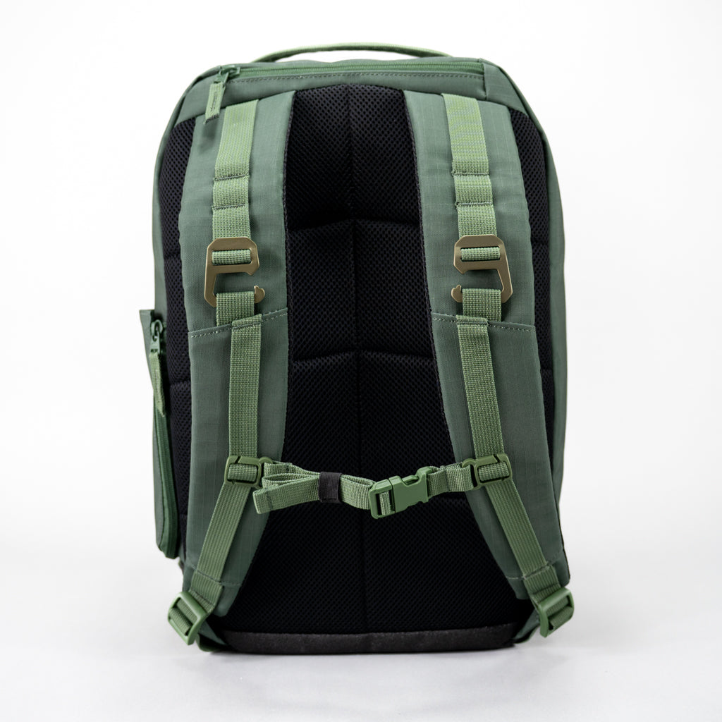 Rear view of the green FORWRD Court Ranger pickleball backpack featuring a ventilated mesh back panel, padded adjustable shoulder straps with sternum buckle, dual heavy duty fence hang hooks, and an external YKK zip accessory pocket.