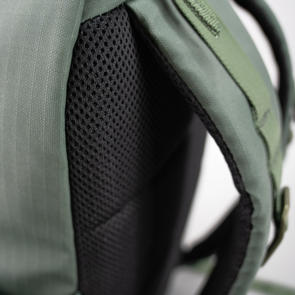 Close-up of the green FORWRD Court Ranger pickleball backpack’s breathable mesh back panel and padded shoulder strap, designed for ergonomic comfort and airflow.