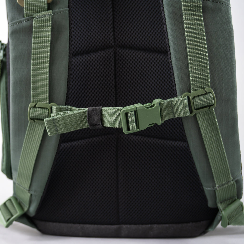 Close-up of the green FORWRD Court Ranger pickleball backpack’s adjustable sternum strap and padded shoulder straps, highlighting the secure chest buckle and breathable mesh back panel.