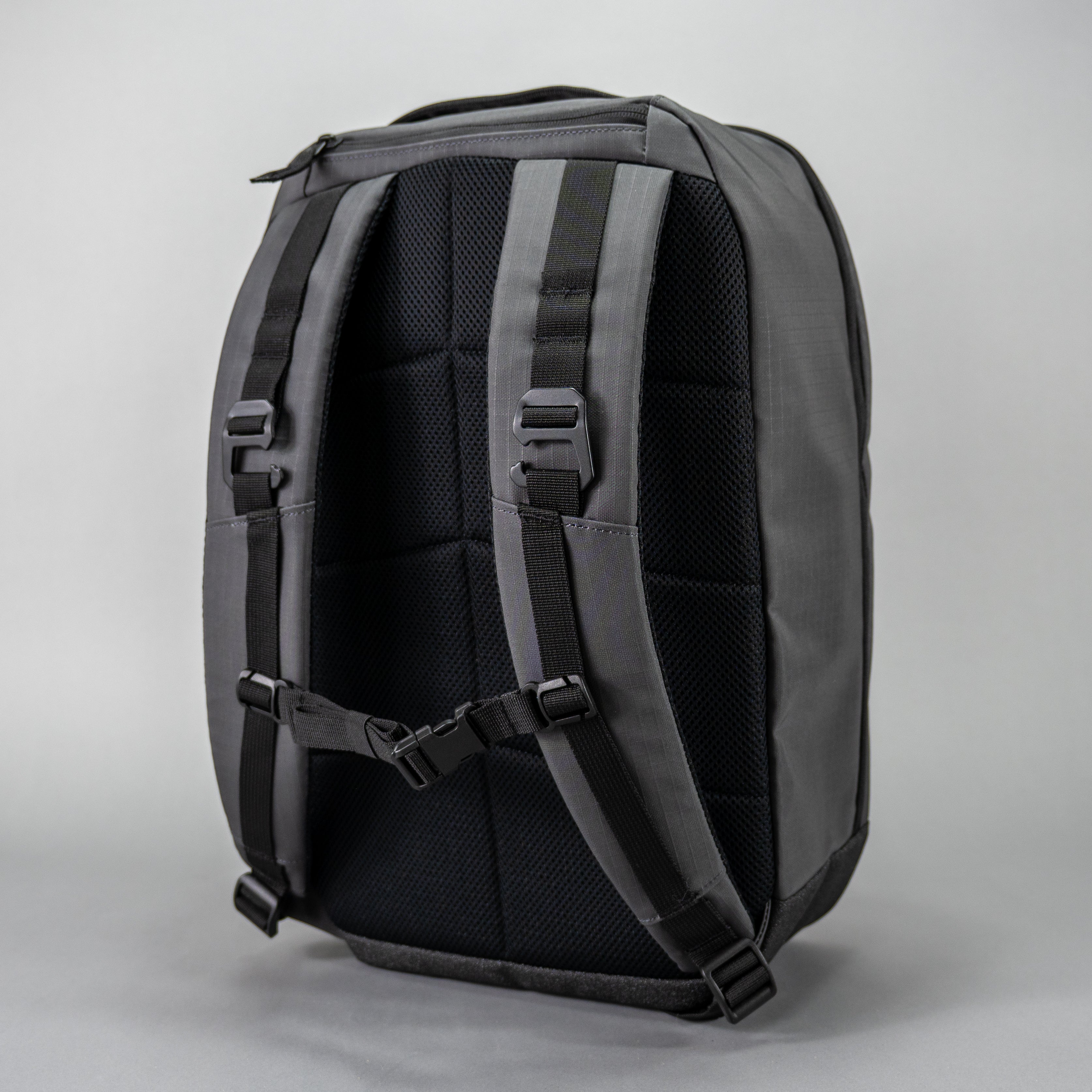 Backpack with black and gray straps on a plain background