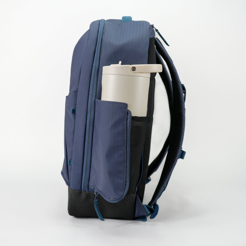 Blue backpack with a white cup holder on a white background