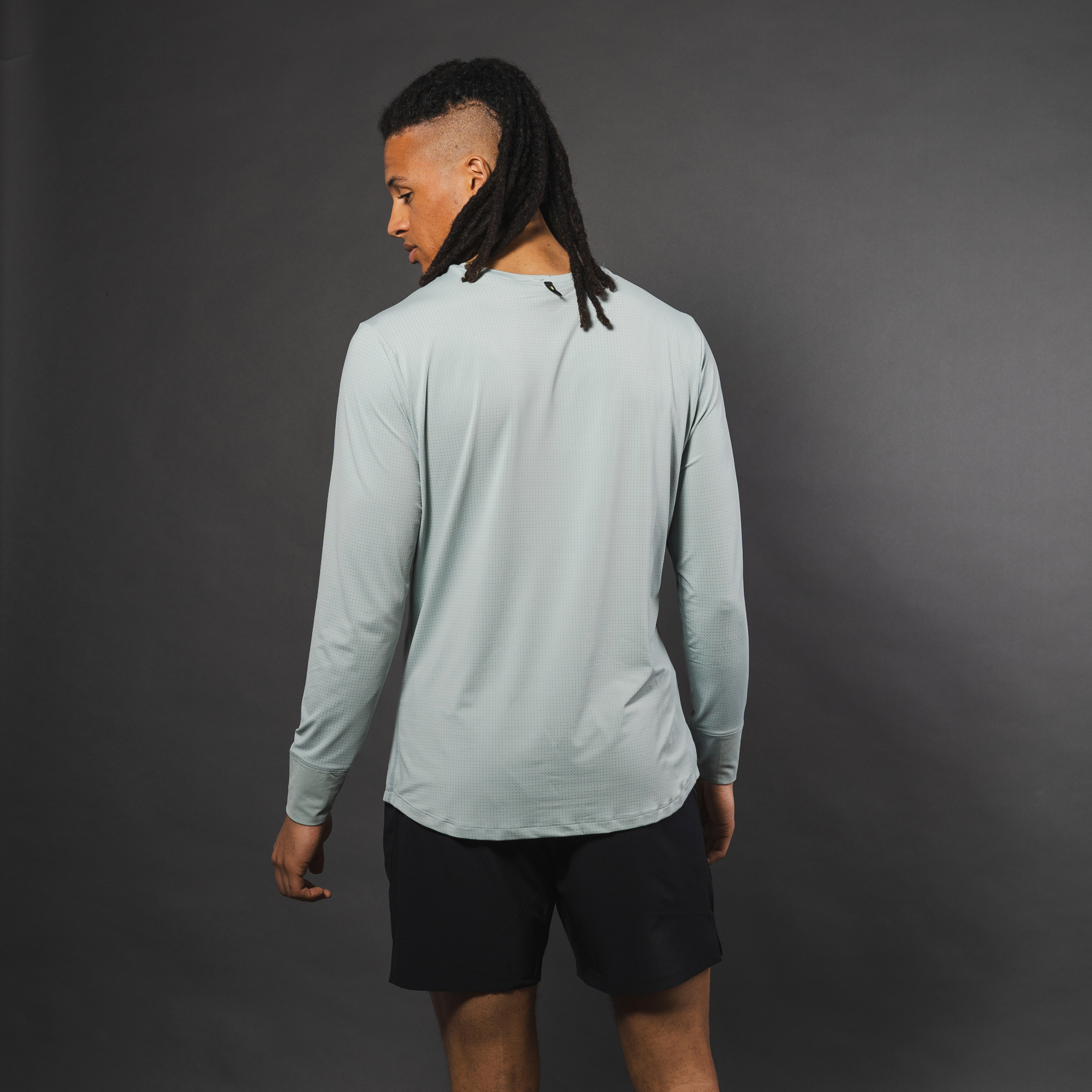 AirLite Men's Long Sleeve - FORWRD - Introducing the AirLite Men's Long Sleeve top, engineered with innovative GripTek™ textured knit on the sleeve cuffs. This top doubles as a convenient towel for quick perspiration management during matches. Experience next-level performance and functionality with this essential piece, ensuring you stay focused and comfortable on the court. Elevate your game with every serve, volley, and smash in this game-changing top.
