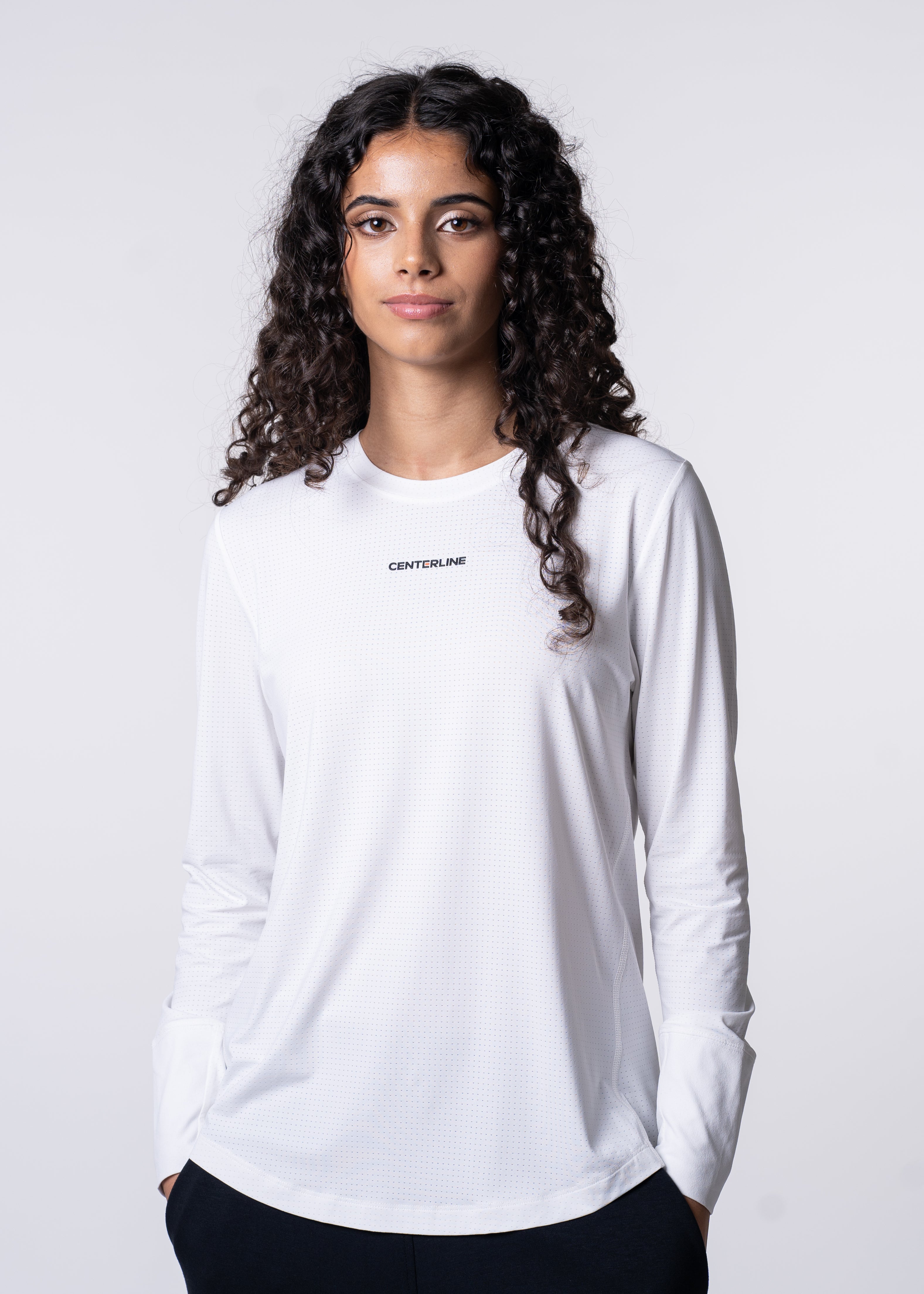 AirLite Women's Long Sleeve - FORWRD - Introducing the AirLite Women's Long Sleeve top, engineered with innovative GripTek™ textured knit on the sleeve cuffs. This top doubles as a convenient towel for quick perspiration management during matches. Experience next-level performance and functionality with this essential piece, ensuring you stay focused and comfortable on the court. Elevate your game with every serve, volley, and smash in this game-changing top.