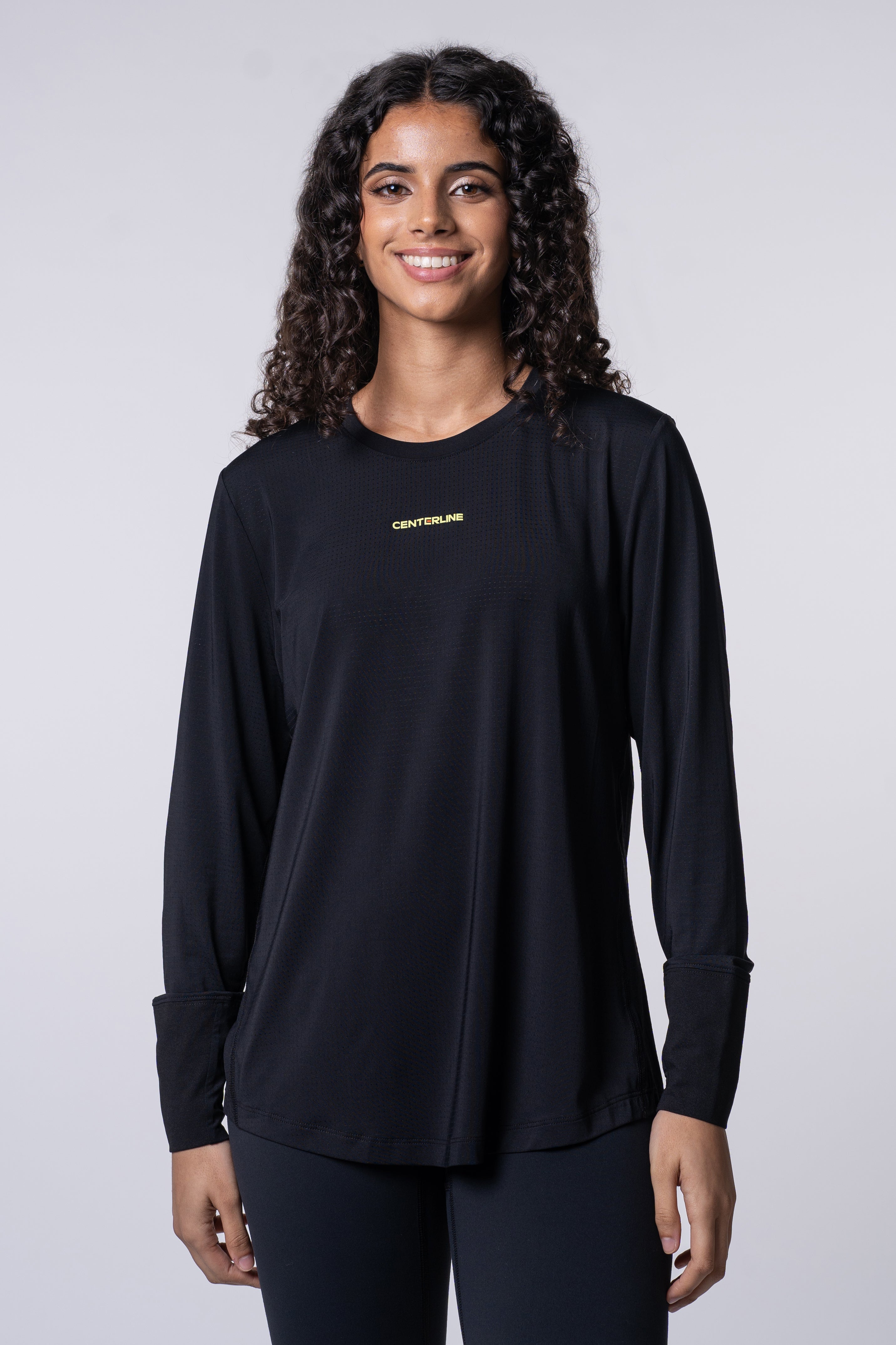 AirLite Women's Long Sleeve - FORWRD - Introducing the AirLite Women's Long Sleeve top, engineered with innovative GripTek™ textured knit on the sleeve cuffs. This top doubles as a convenient towel for quick perspiration management during matches. Experience next-level performance and functionality with this essential piece, ensuring you stay focused and comfortable on the court. Elevate your game with every serve, volley, and smash in this game-changing top.
