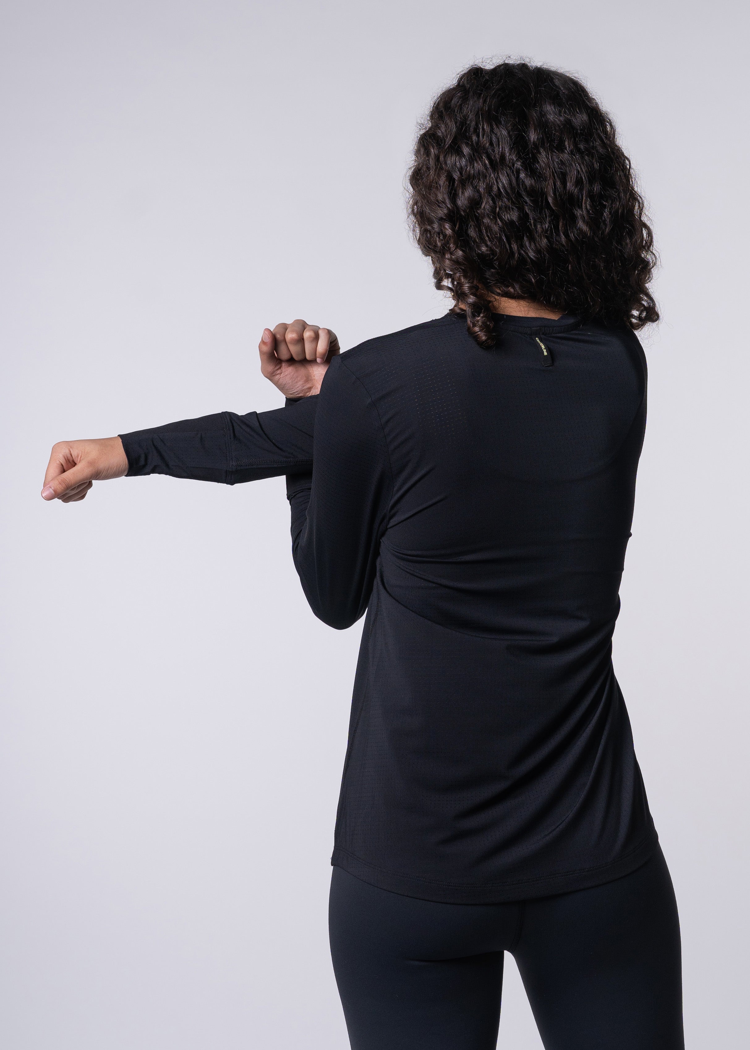 AirLite Women's Long Sleeve - FORWRD - Introducing the AirLite Women's Long Sleeve top, engineered with innovative GripTek™ textured knit on the sleeve cuffs. This top doubles as a convenient towel for quick perspiration management during matches. Experience next-level performance and functionality with this essential piece, ensuring you stay focused and comfortable on the court. Elevate your game with every serve, volley, and smash in this game-changing top.