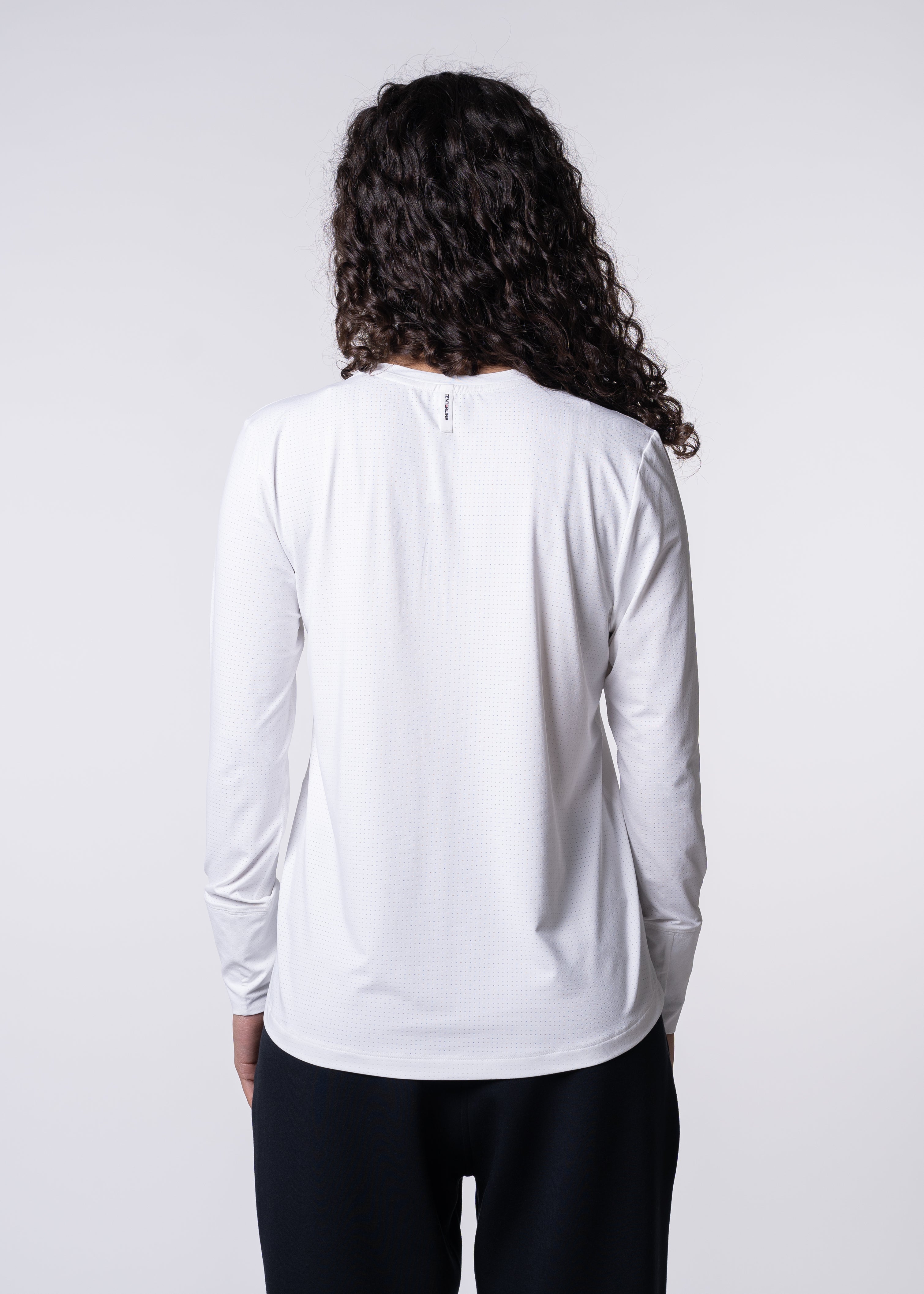 AirLite Women's Long Sleeve - FORWRD - Introducing the AirLite Women's Long Sleeve top, engineered with innovative GripTek™ textured knit on the sleeve cuffs. This top doubles as a convenient towel for quick perspiration management during matches. Experience next-level performance and functionality with this essential piece, ensuring you stay focused and comfortable on the court. Elevate your game with every serve, volley, and smash in this game-changing top.