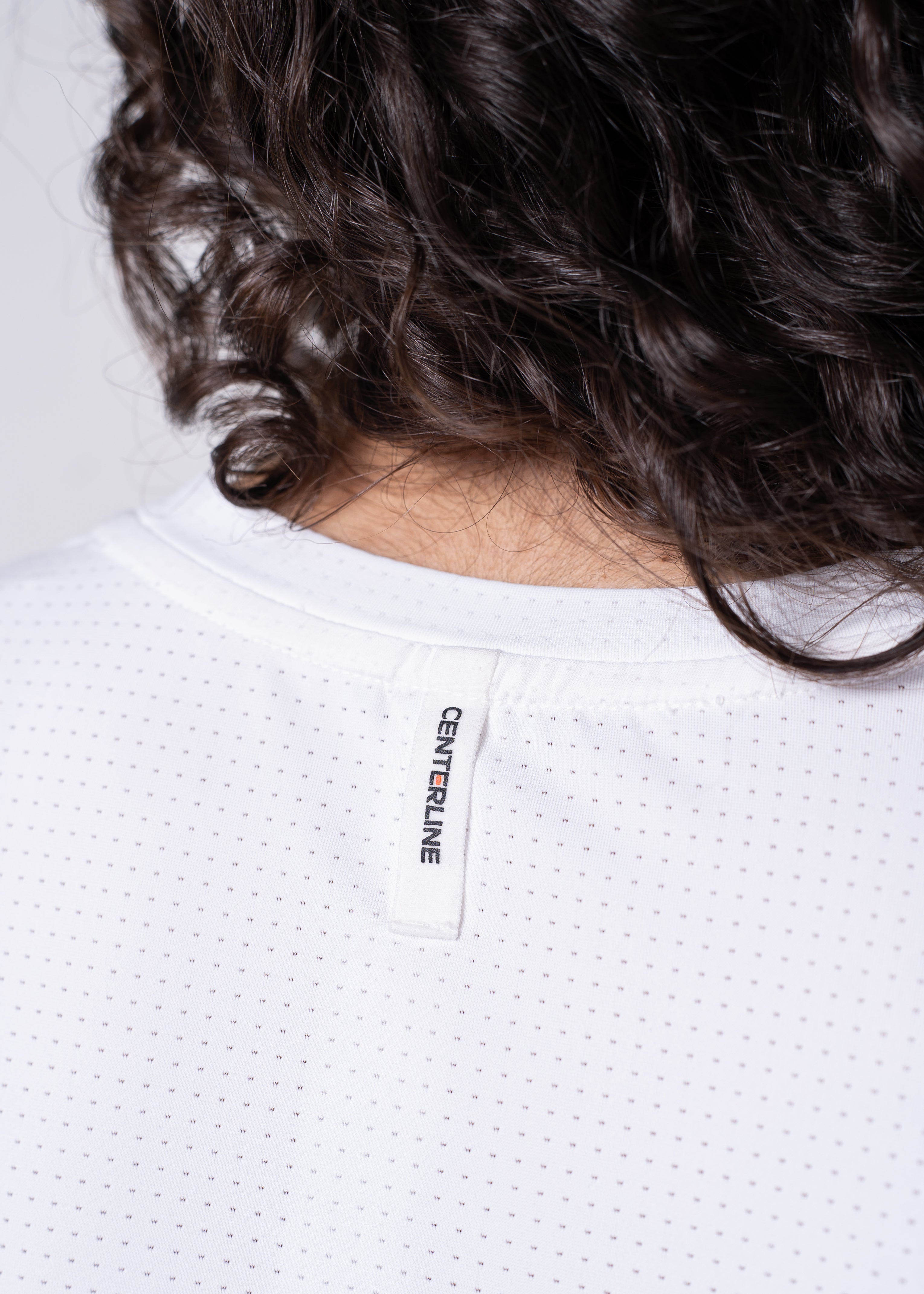 AirLite Women's Long Sleeve - FORWRD - Introducing the AirLite Women's Long Sleeve top, engineered with innovative GripTek™ textured knit on the sleeve cuffs. This top doubles as a convenient towel for quick perspiration management during matches. Experience next-level performance and functionality with this essential piece, ensuring you stay focused and comfortable on the court. Elevate your game with every serve, volley, and smash in this game-changing top.