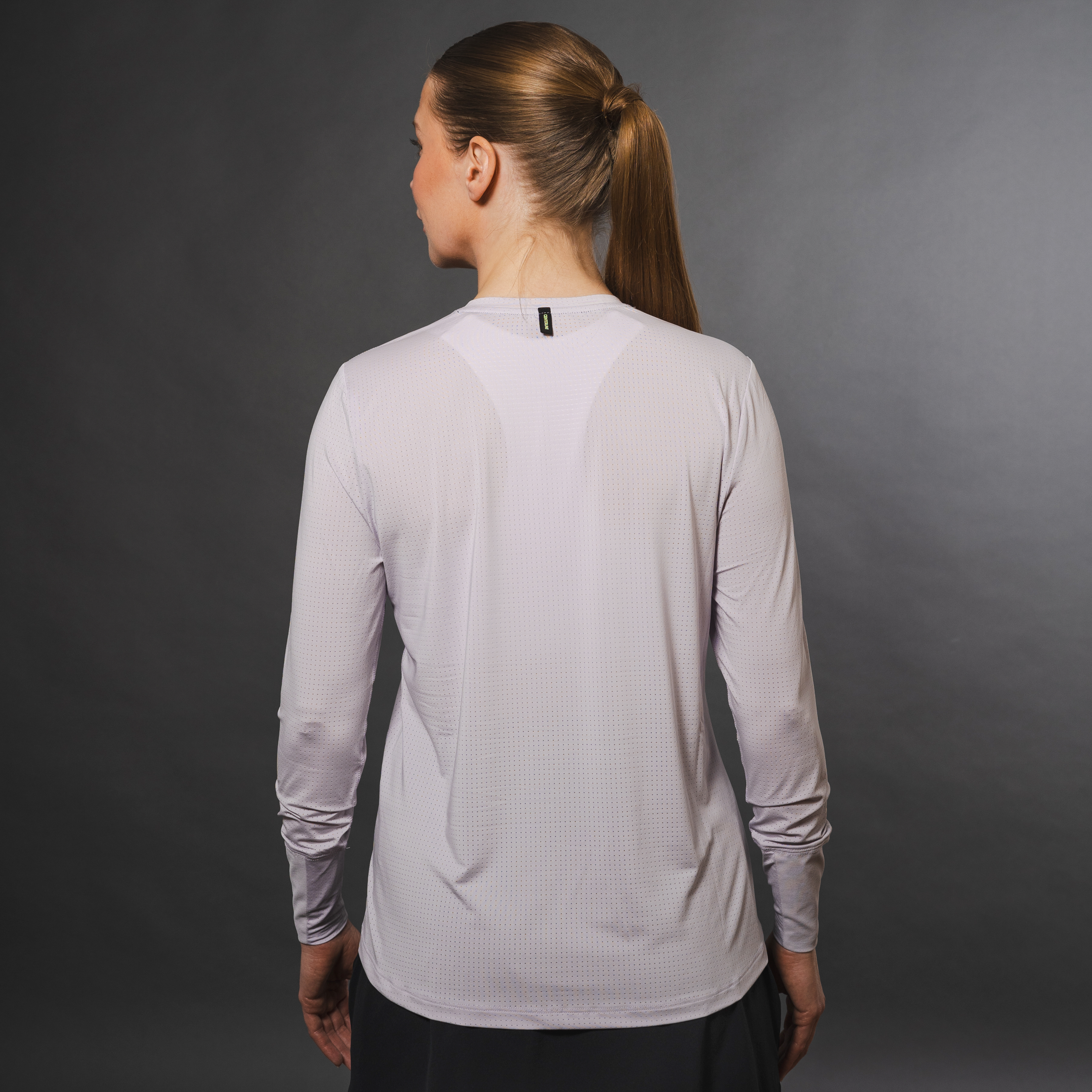 AirLite Women's Long Sleeve - FORWRD - Introducing the AirLite Women's Long Sleeve top, engineered with innovative GripTek™ textured knit on the sleeve cuffs. This top doubles as a convenient towel for quick perspiration management during matches. Experience next-level performance and functionality with this essential piece, ensuring you stay focused and comfortable on the court. Elevate your game with every serve, volley, and smash in this game-changing top.
