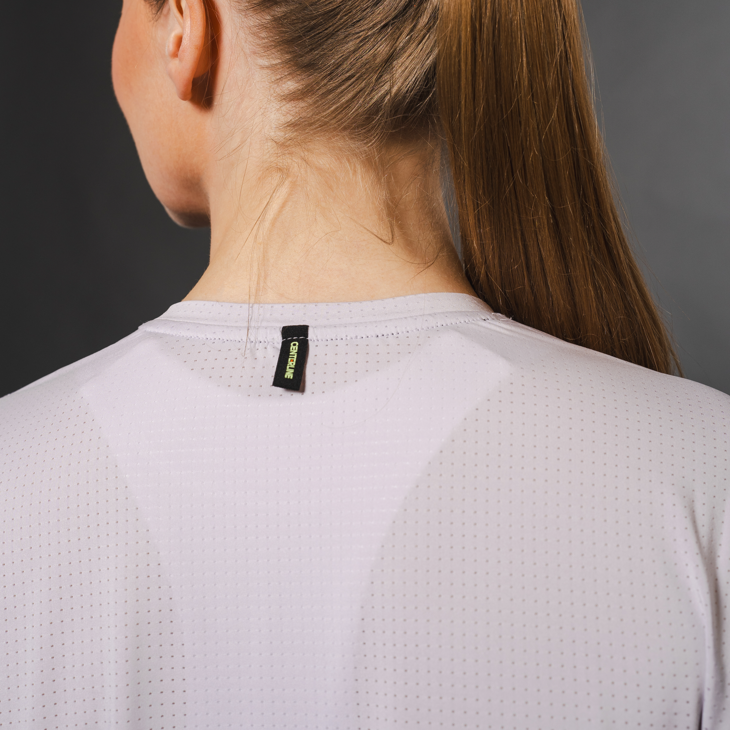 AirLite Women's Long Sleeve - FORWRD - Introducing the AirLite Women's Long Sleeve top, engineered with innovative GripTek™ textured knit on the sleeve cuffs. This top doubles as a convenient towel for quick perspiration management during matches. Experience next-level performance and functionality with this essential piece, ensuring you stay focused and comfortable on the court. Elevate your game with every serve, volley, and smash in this game-changing top.