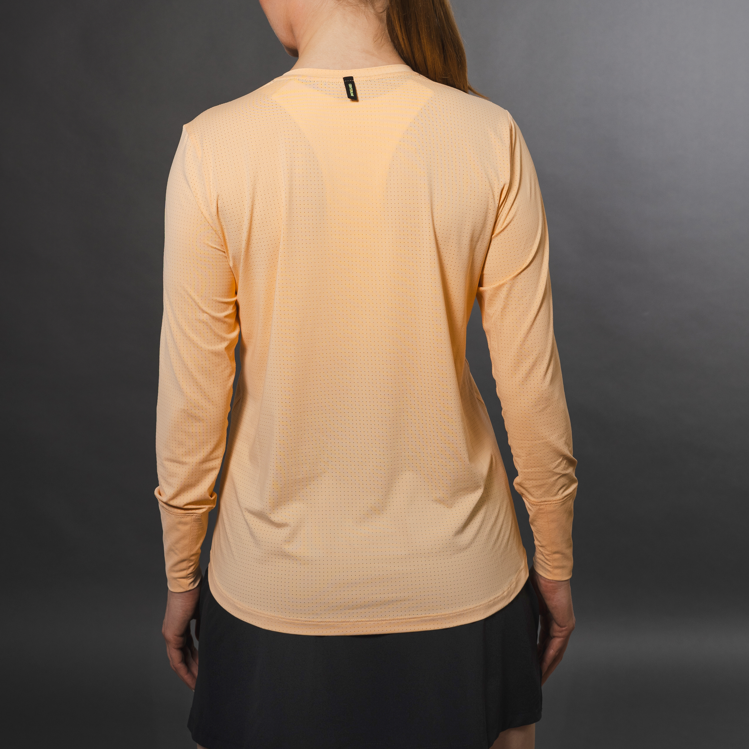 AirLite Women's Long Sleeve - FORWRD - Introducing the AirLite Women's Long Sleeve top, engineered with innovative GripTek™ textured knit on the sleeve cuffs. This top doubles as a convenient towel for quick perspiration management during matches. Experience next-level performance and functionality with this essential piece, ensuring you stay focused and comfortable on the court. Elevate your game with every serve, volley, and smash in this game-changing top.