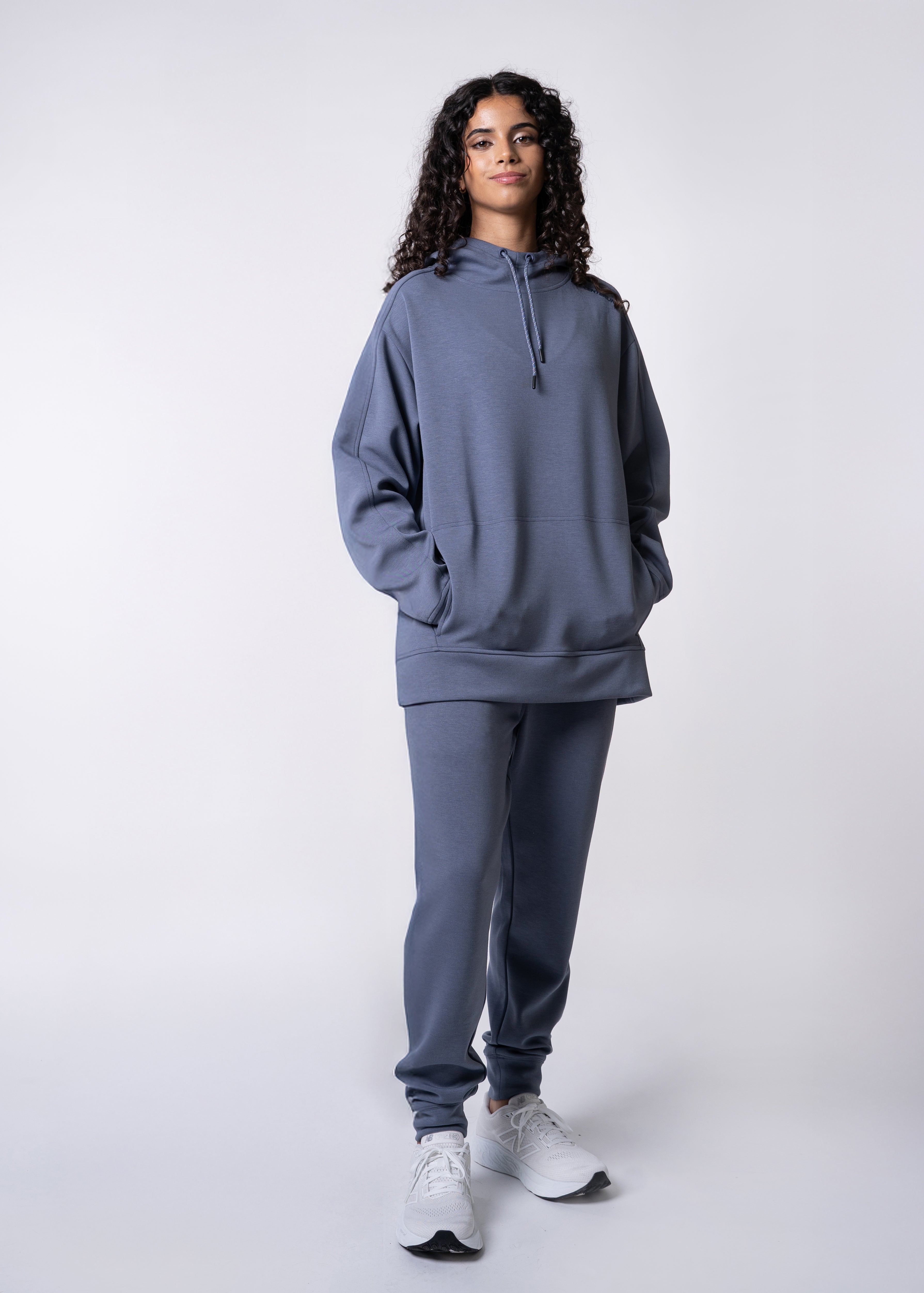 Apres Unisex Hooded Sweatshirt - FORWRD - The ultimate post-game hooded pullover, designed with a relaxed varsity-inspired fit for comfort and style. Soft and comfortable, water repellent fabric, with a fully functional hood with adjustable draw cord helps keep you protected from the elements. Front hand pockets offer a secure phone storage option, adding practicality to this street-style piece that easily transitions from court to casual activities. This unisex hoodie has an athletic fit