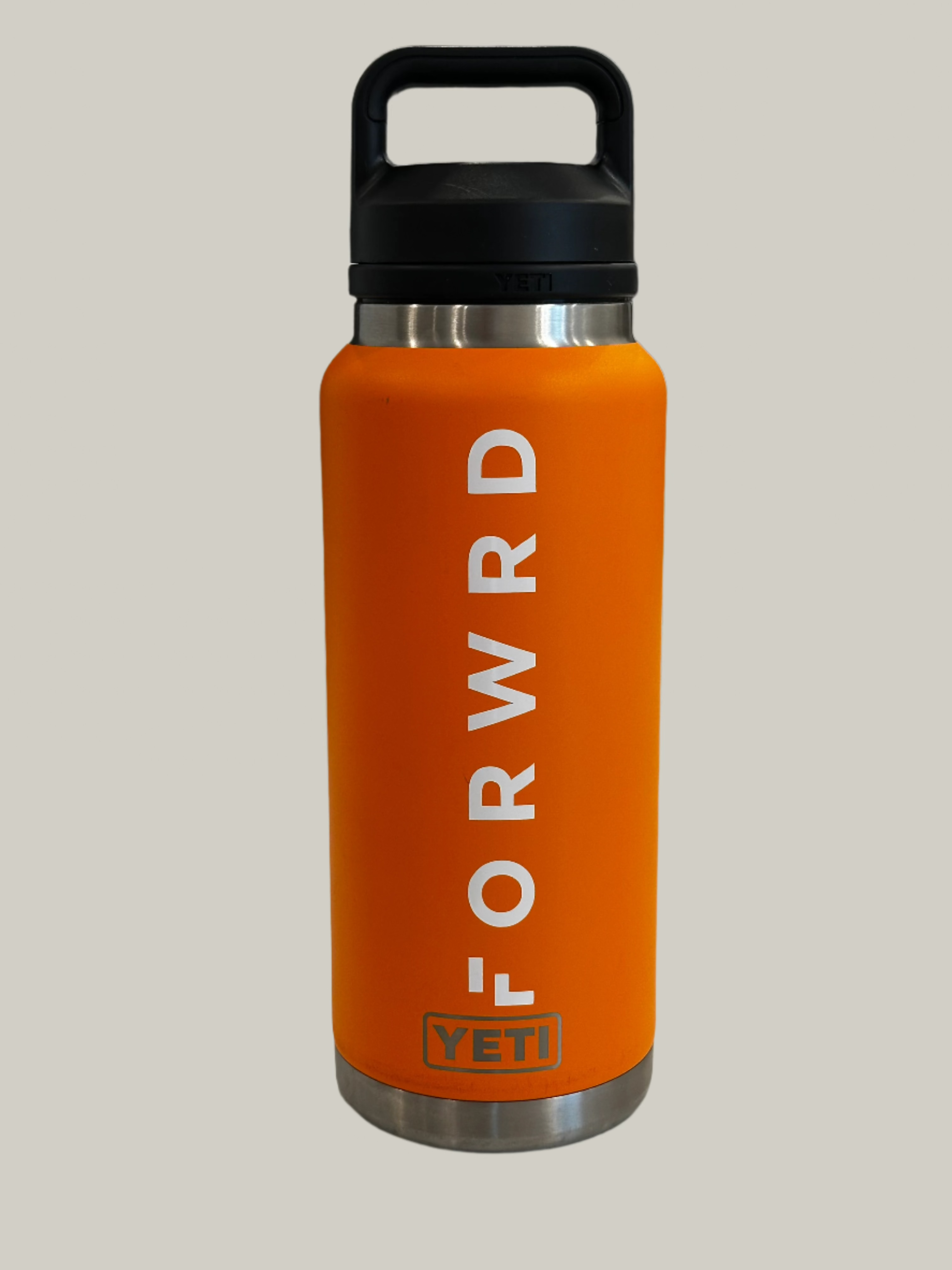 orange bottle with black lid and forwrd sticker in white
