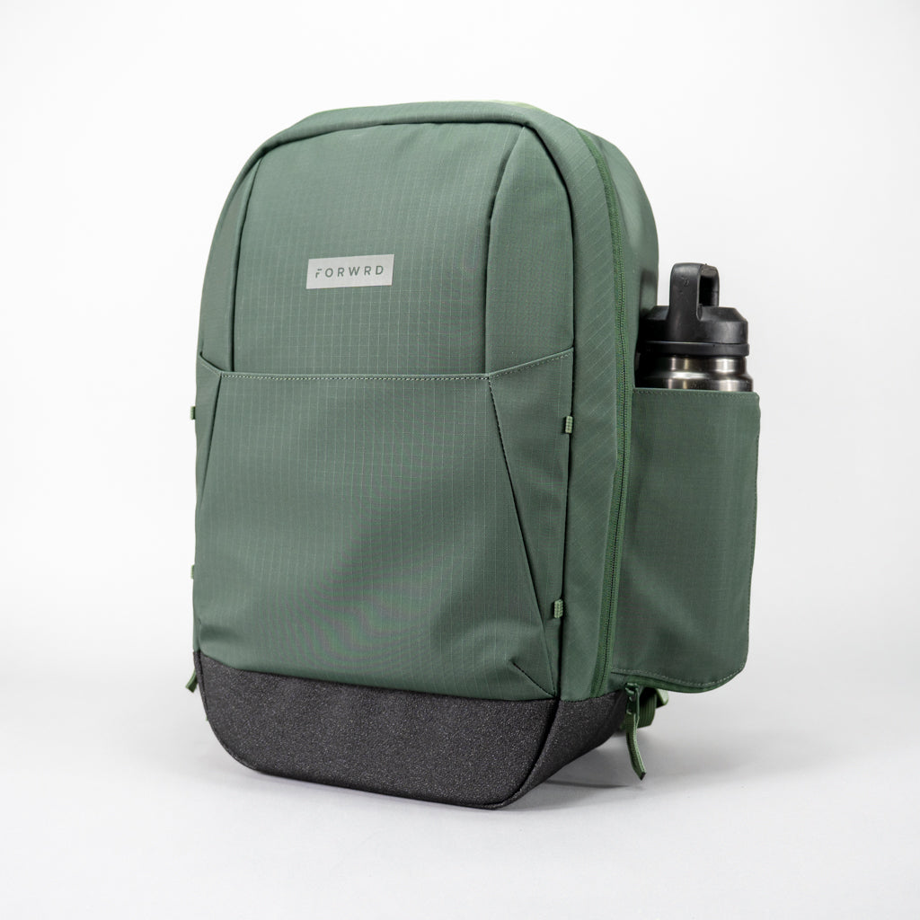 Green FORWRD Court Ranger pickleball backpack with a stainless steel water bottle in its side pocket, crafted from ripstop fabric with a reinforced base and large front integrated paddle sleeve front pocket.