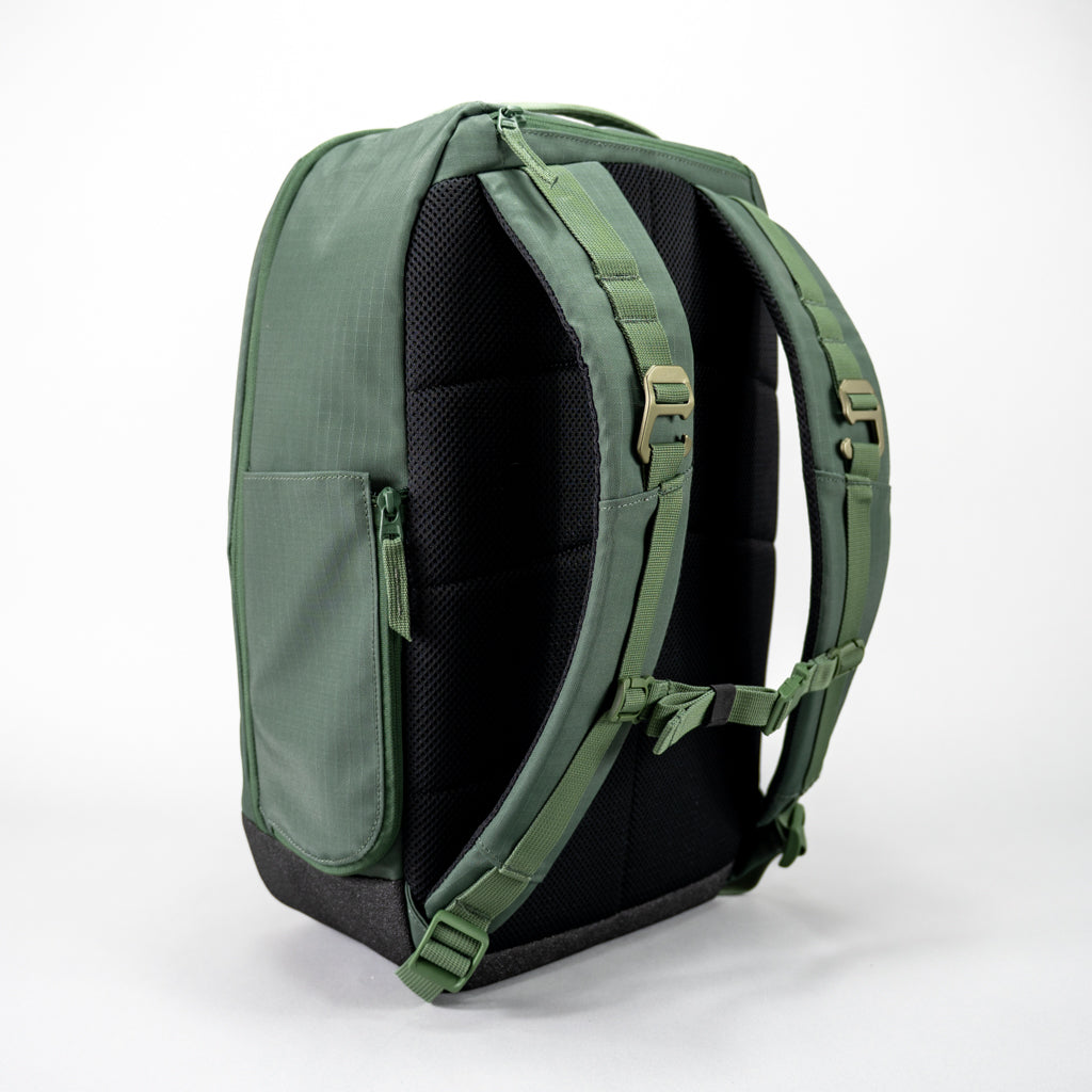 Rear view of the green FORWRD Court Ranger pickleball backpack featuring a ventilated mesh back panel, padded adjustable shoulder straps with sternum buckle, dual fence hang hooks, and a side zip pocket to expand the water bottle holder