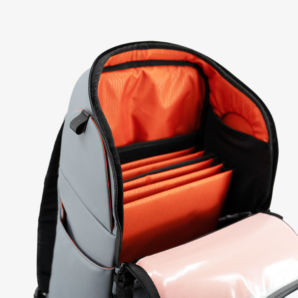 Backpack with orange interior and pink item partially visible