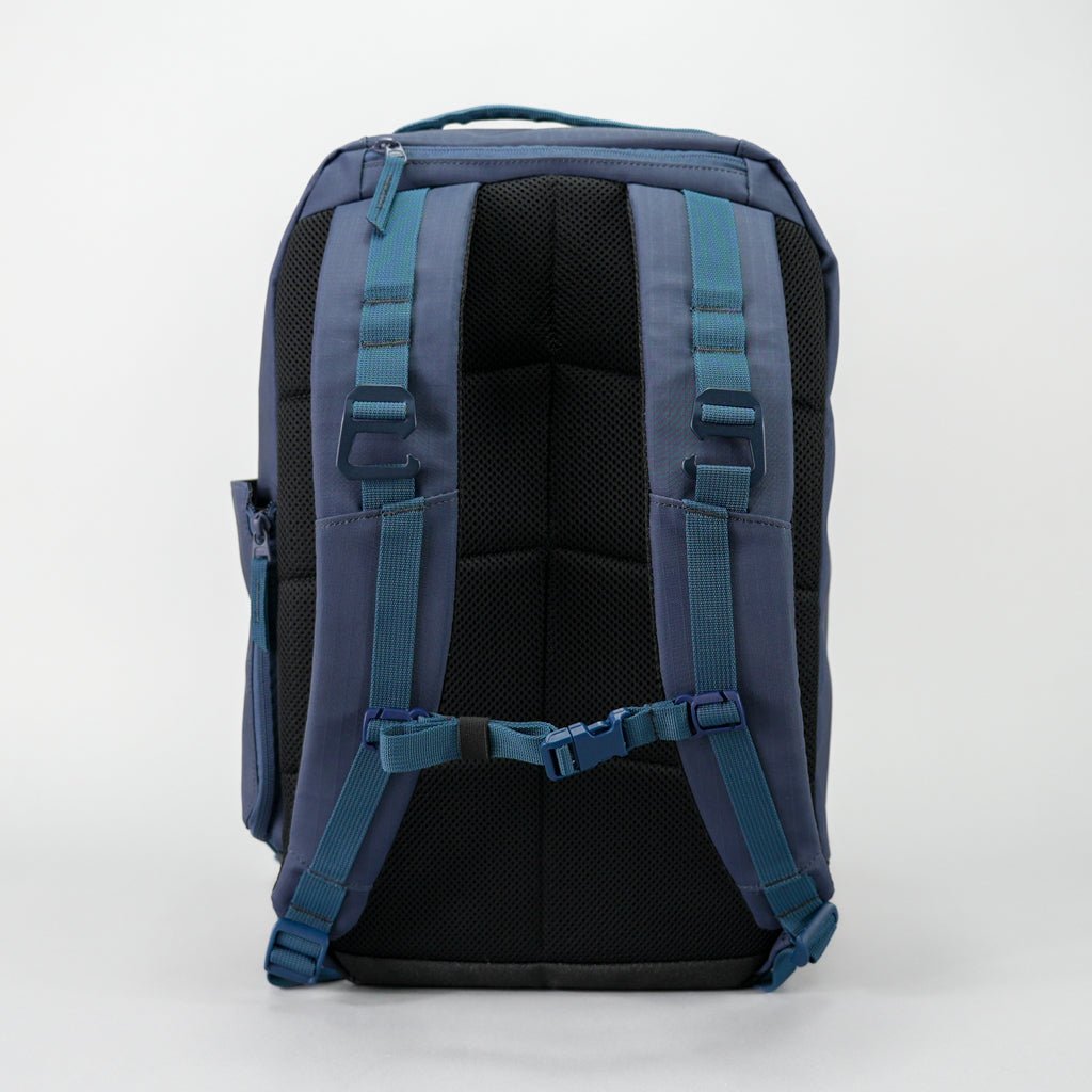 Back view of a blue backpack on a white background