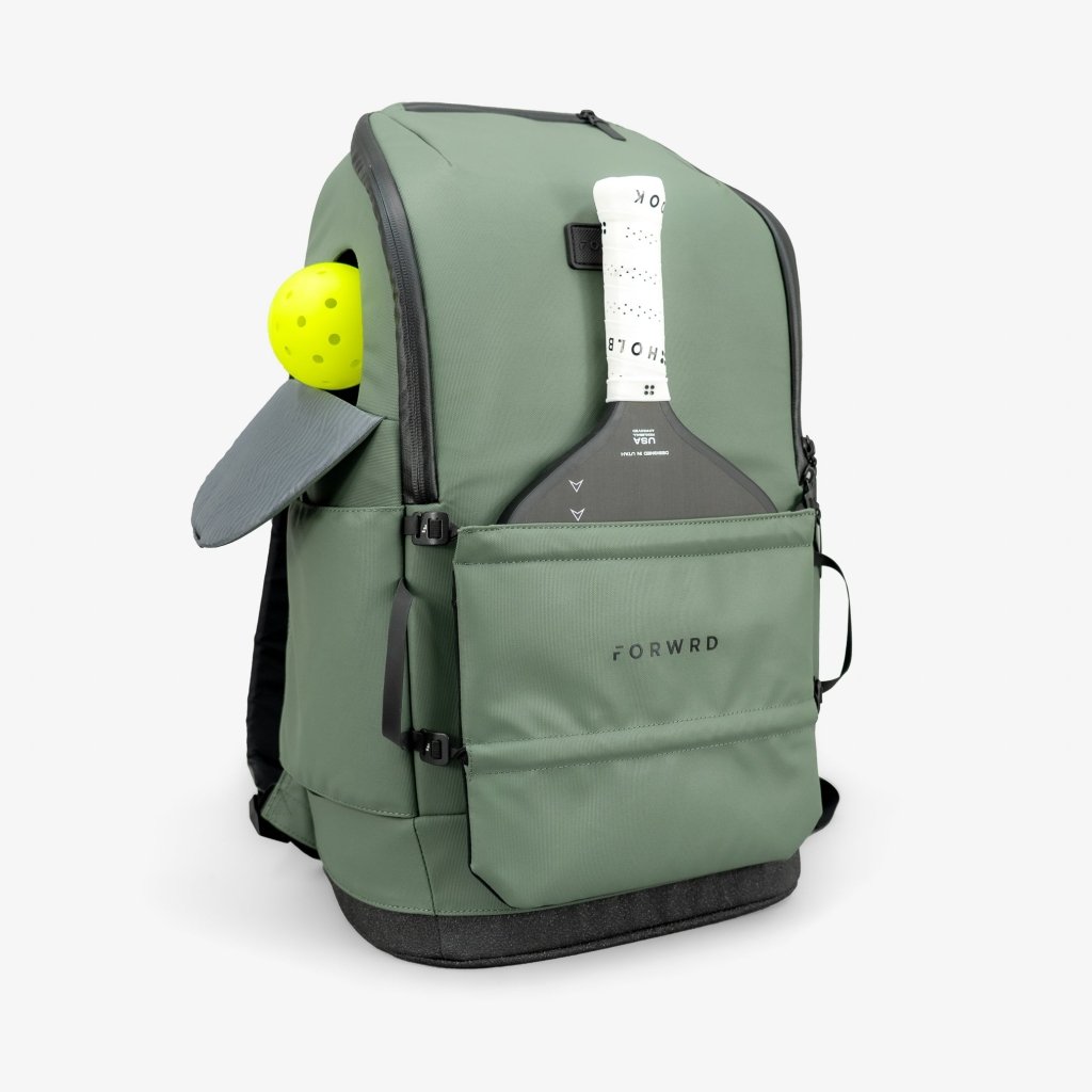 Green backpack with a paddle and ball on a white background