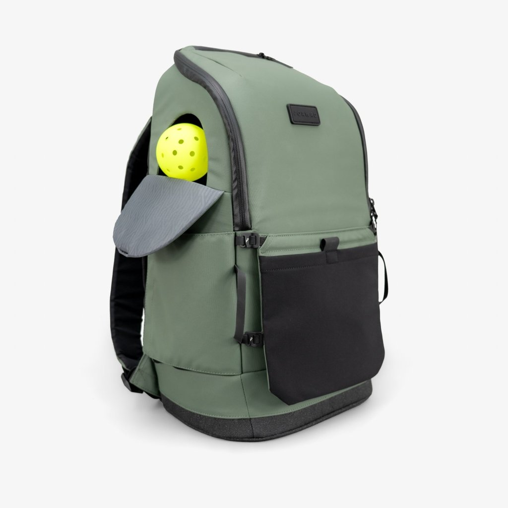 Green backpack with a yellow ball in the front pocket on a white background