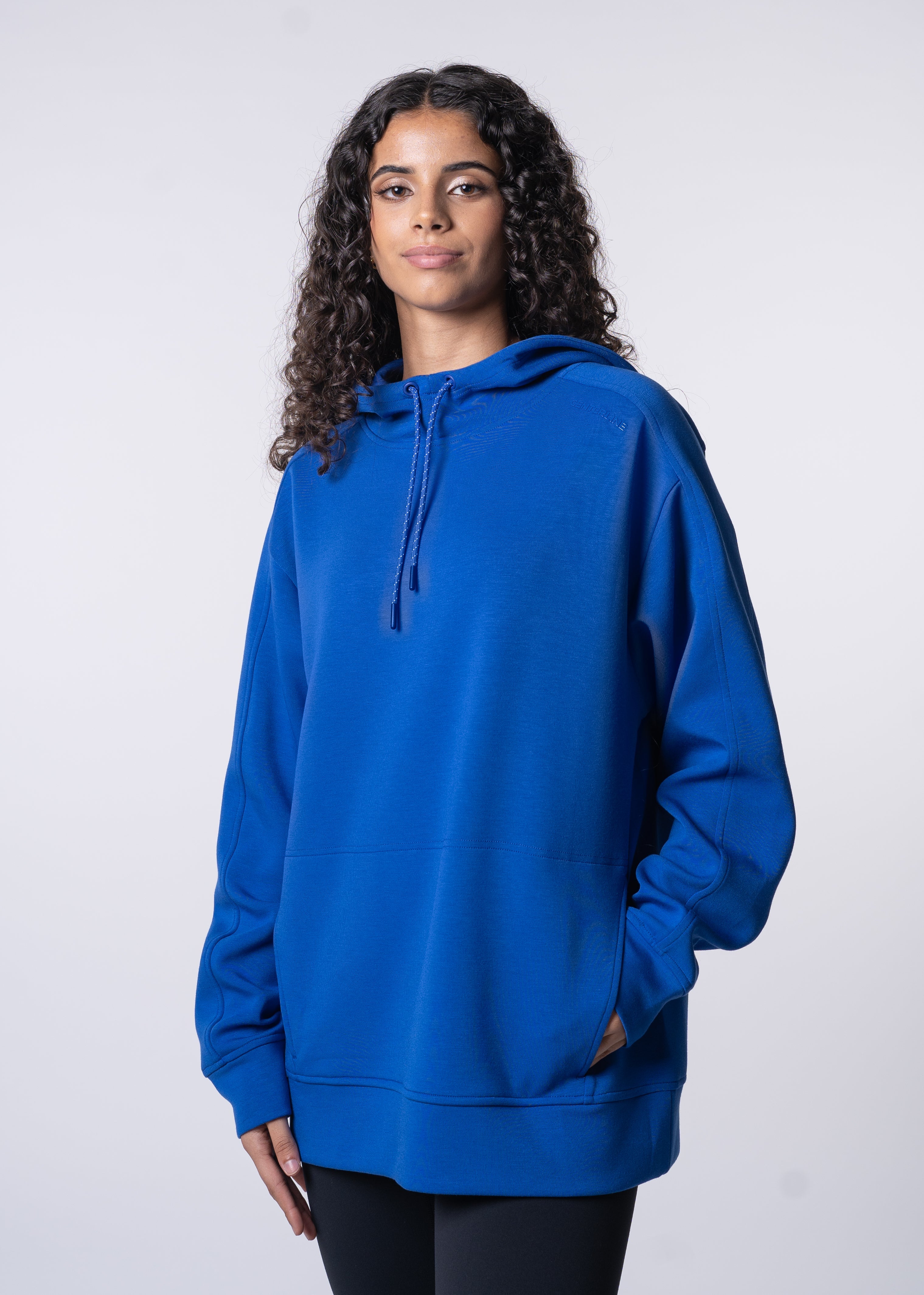 Apres Unisex Hooded Sweatshirt - FORWRD  -  The ultimate post-game hooded pullover, designed with a relaxed varsity-inspired fit for comfort and style. Soft and comfortable, water repellent fabric, with a fully functional hood with adjustable draw cord helps keep you protected from the elements. Front hand pockets offer a secure phone storage option, adding practicality to this street-style piece that easily transitions from court to casual activities. This unisex hoodie has an athletic fit