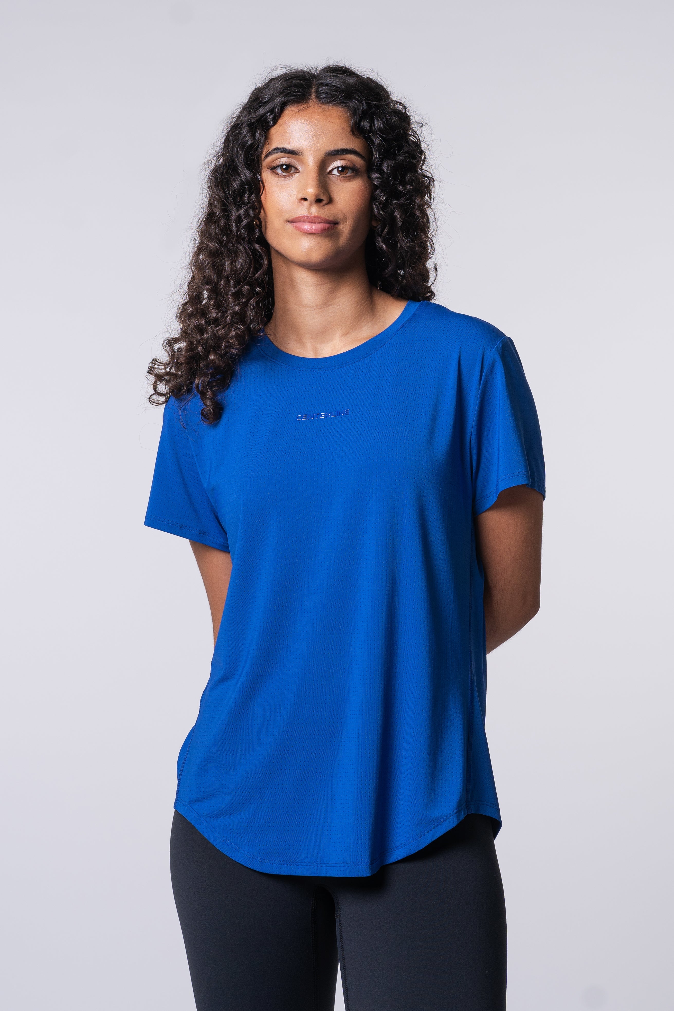 AirLite Women's Tee - FORWRD  -  Elevate your game with the AirLite Women's Tee, engineered from ultra-breathable mesh fabric for unmatched ventilation during pickleball play. Curved hem ensures confidence in every move, allowing you to showcase your agility without compromising on comfort. Experience the perfect blend of style and performance with this essential addition to your wardrobe.