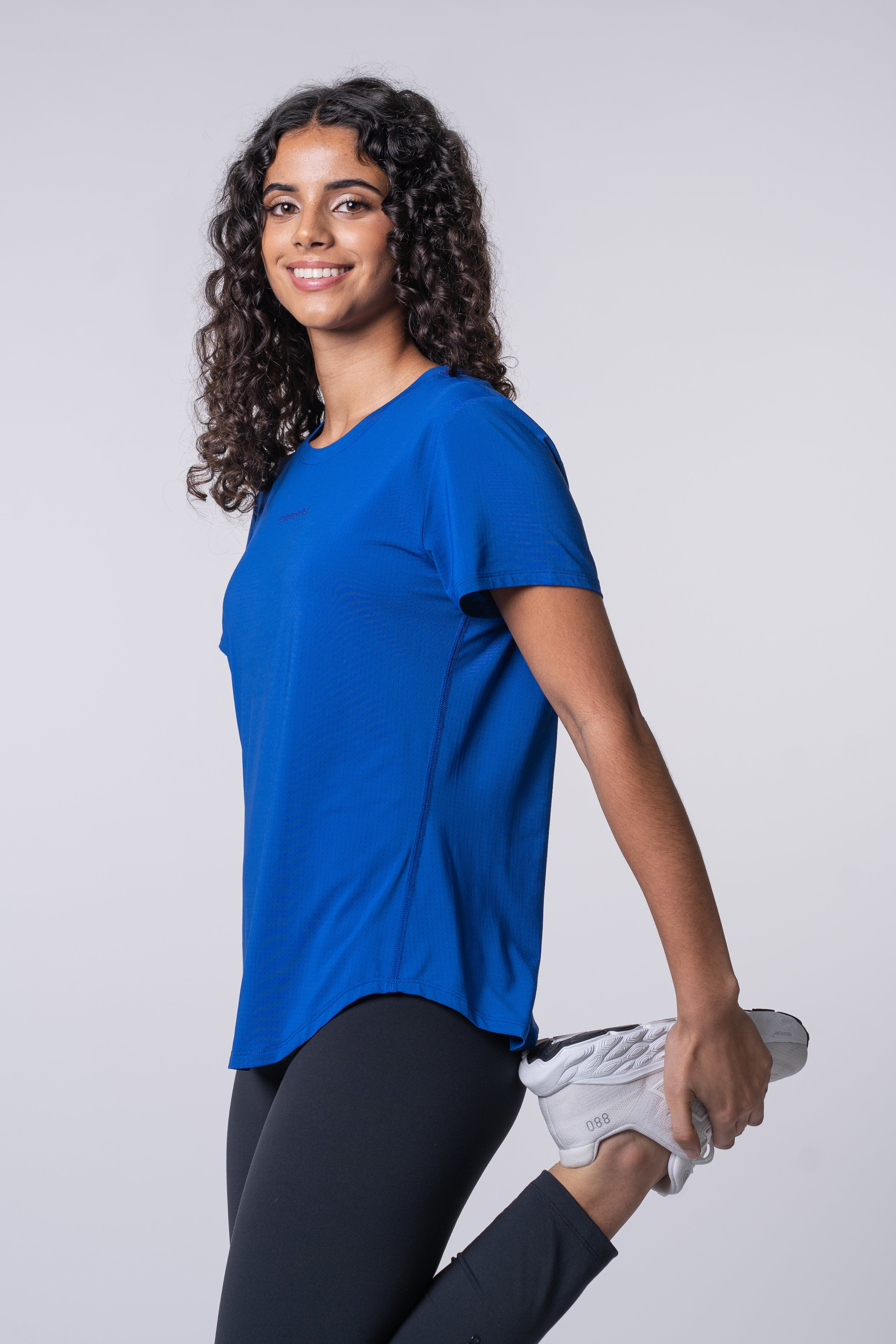 AirLite Women's Tee - FORWRD  -  Elevate your game with the AirLite Women's Tee, engineered from ultra-breathable mesh fabric for unmatched ventilation during pickleball play. Curved hem ensures confidence in every move, allowing you to showcase your agility without compromising on comfort. Experience the perfect blend of style and performance with this essential addition to your wardrobe.