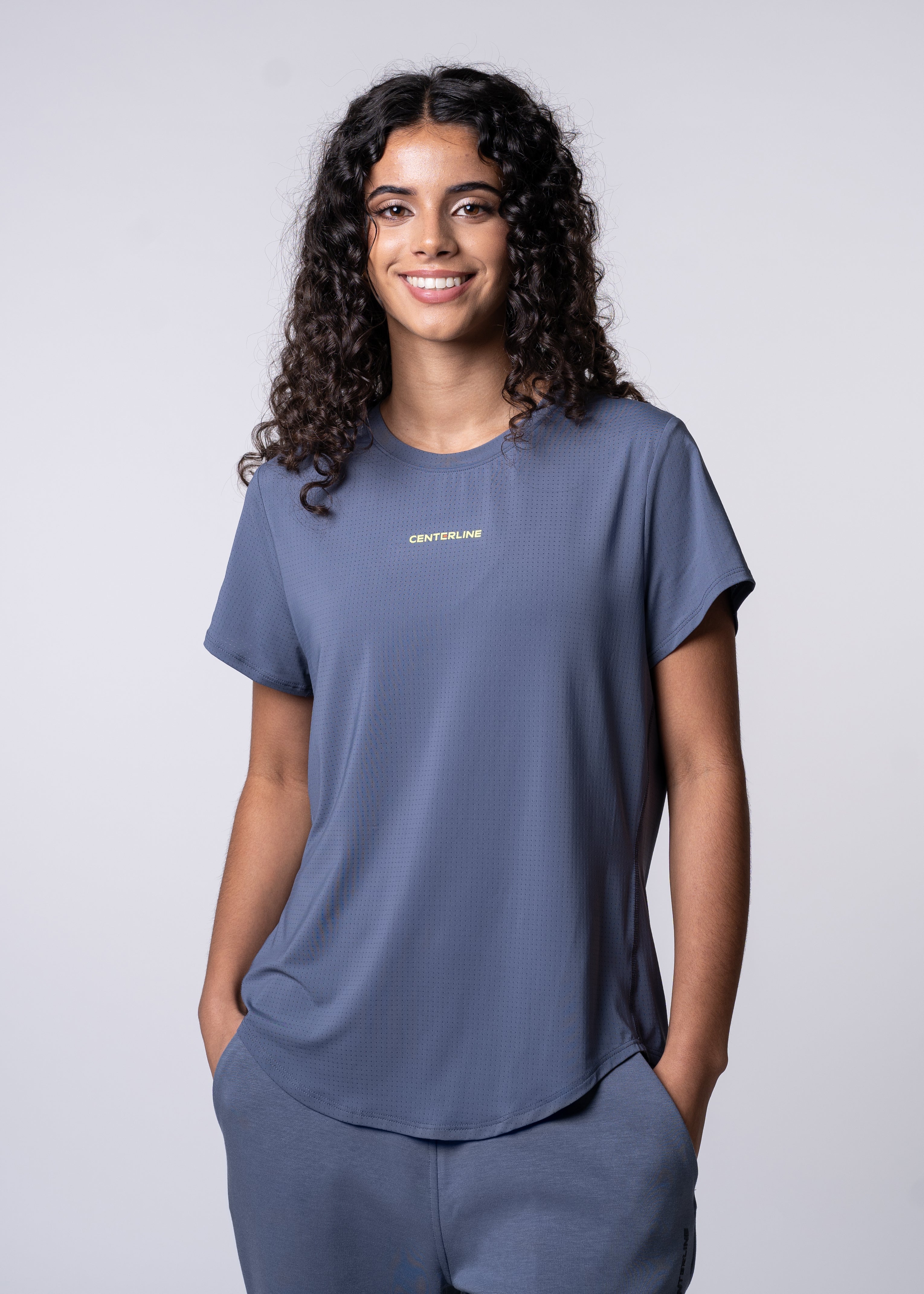 AirLite Women's Tee - FORWRD  -  Elevate your game with the AirLite Women's Tee, engineered from ultra-breathable mesh fabric for unmatched ventilation during pickleball play. Curved hem ensures confidence in every move, allowing you to showcase your agility without compromising on comfort. Experience the perfect blend of style and performance with this essential addition to your wardrobe.