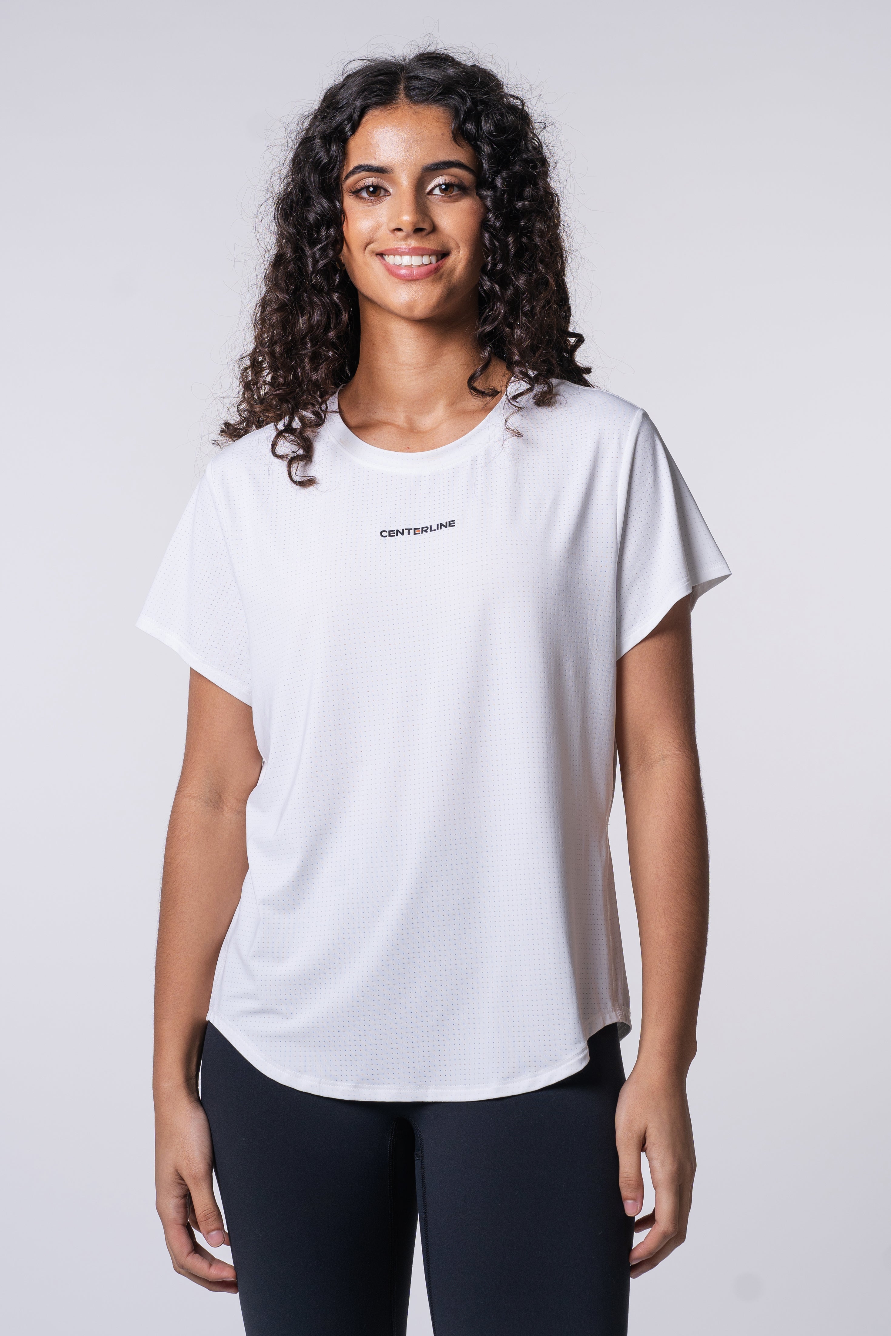 AirLite Women's Tee - FORWRD  -  Elevate your game with the AirLite Women's Tee, engineered from ultra-breathable mesh fabric for unmatched ventilation during pickleball play. Curved hem ensures confidence in every move, allowing you to showcase your agility without compromising on comfort. Experience the perfect blend of style and performance with this essential addition to your wardrobe.