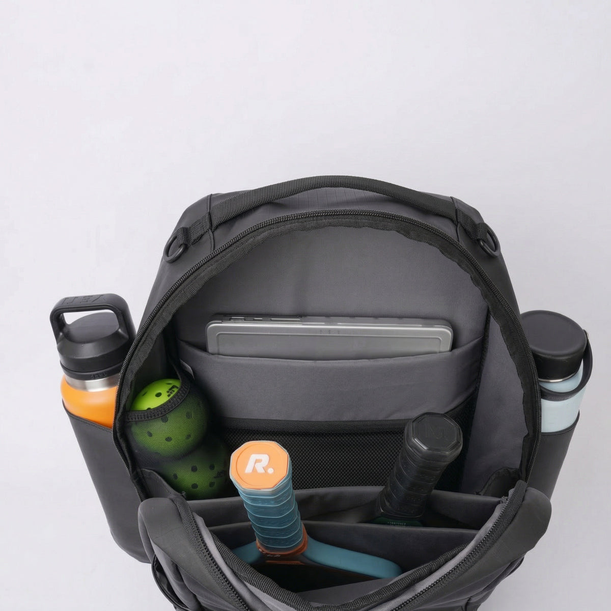 Court Ranger V2 open interior showing 16-inch laptop sleeve with laptop and gear inside