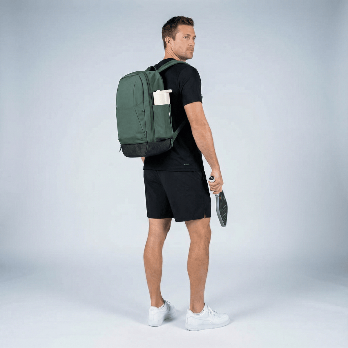 Player wearing Court Ranger V2 backpack in everyday setting — looks like a premium everyday backpack, not a sports bag