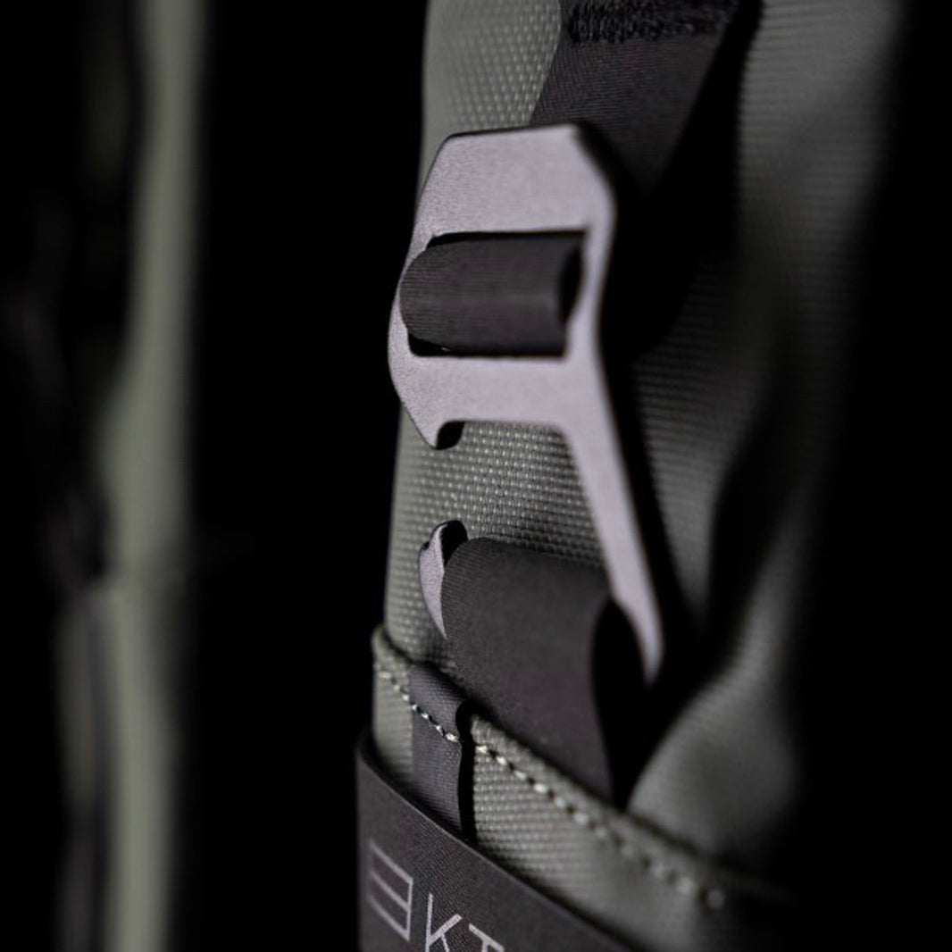 Close-up of a sturdy metal buckle on the green KTCHN pickleball backpack, highlighting premium materials and secure gear storage.