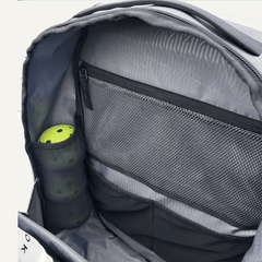 Gray backpack with a compartment containing a green pickleball paddle and ball.